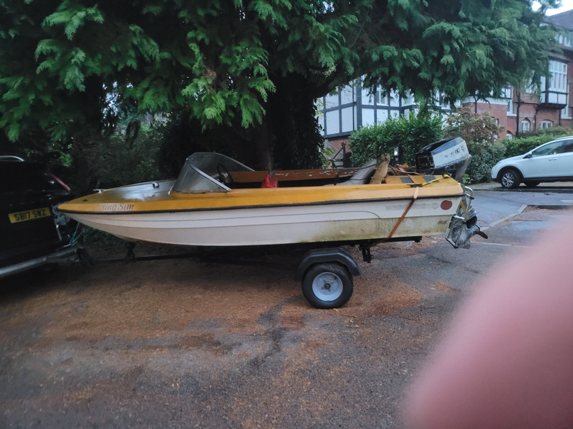 The speed boat as purchased &mdash; yellow/white hull, weathered and stripped