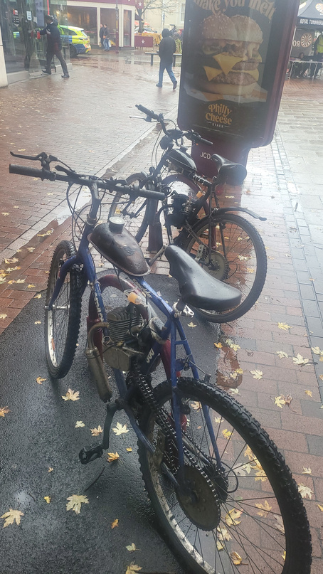 The two completed motor-bikes parked side by side in town