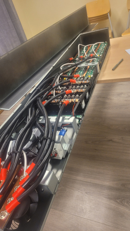 Inside the assembled distribution panel &mdash; busbars, breakers and the PCB interior