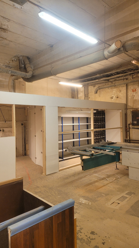 Warehouse interior during build-out &mdash; shelving and ducting going in