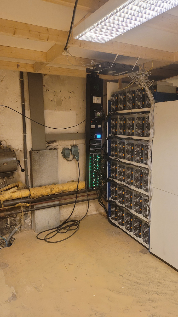 Stack of ASIC Bitcoin miners in a Norwegian basement, with custom cable management