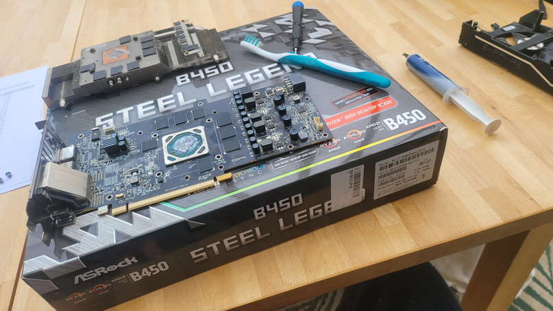 ASRock B450 Steel Legend motherboard laid out on the box during a build