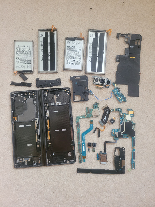 Full Samsung phone teardown laid out &mdash; batteries, logic boards, cameras, flex cables