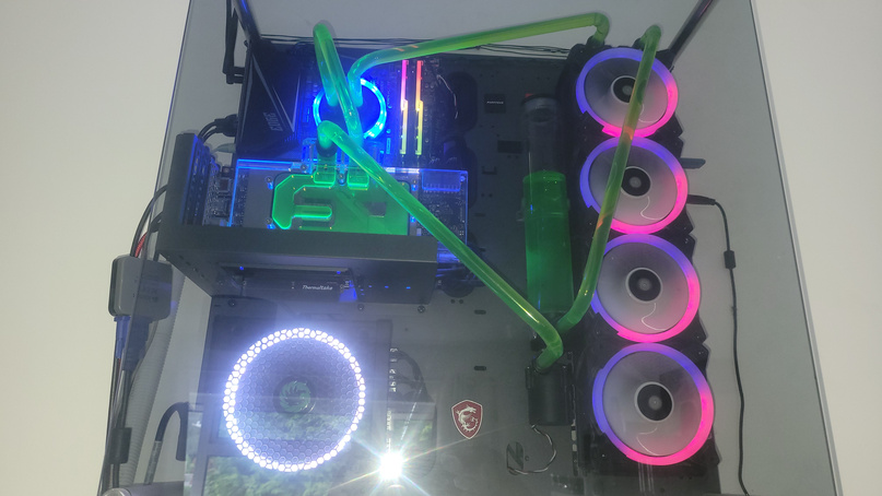 Custom hard-line water-cooled PC with green coolant and RGB fans